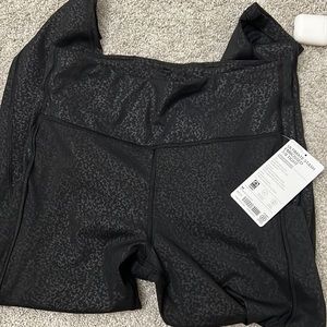 ATHLETA —- NWT ULTIMATE STASH 7/8 TIGHT — BLACK EMBOSSED